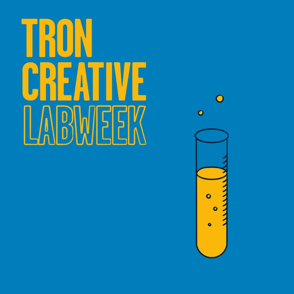 Tron Creative Labweek text next to a test tube with yellow liquid in it and two bubbles coming out of the top.
